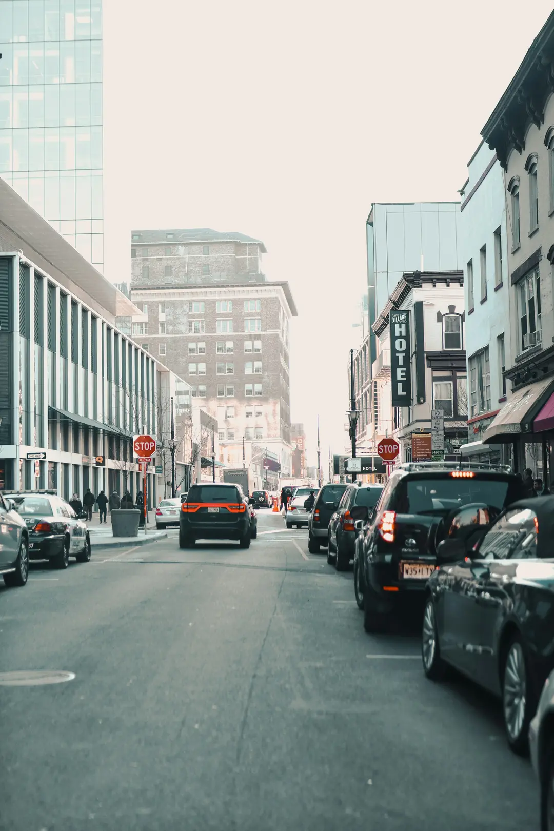 A street in Newark lined with parked cars and mid-rise buildings